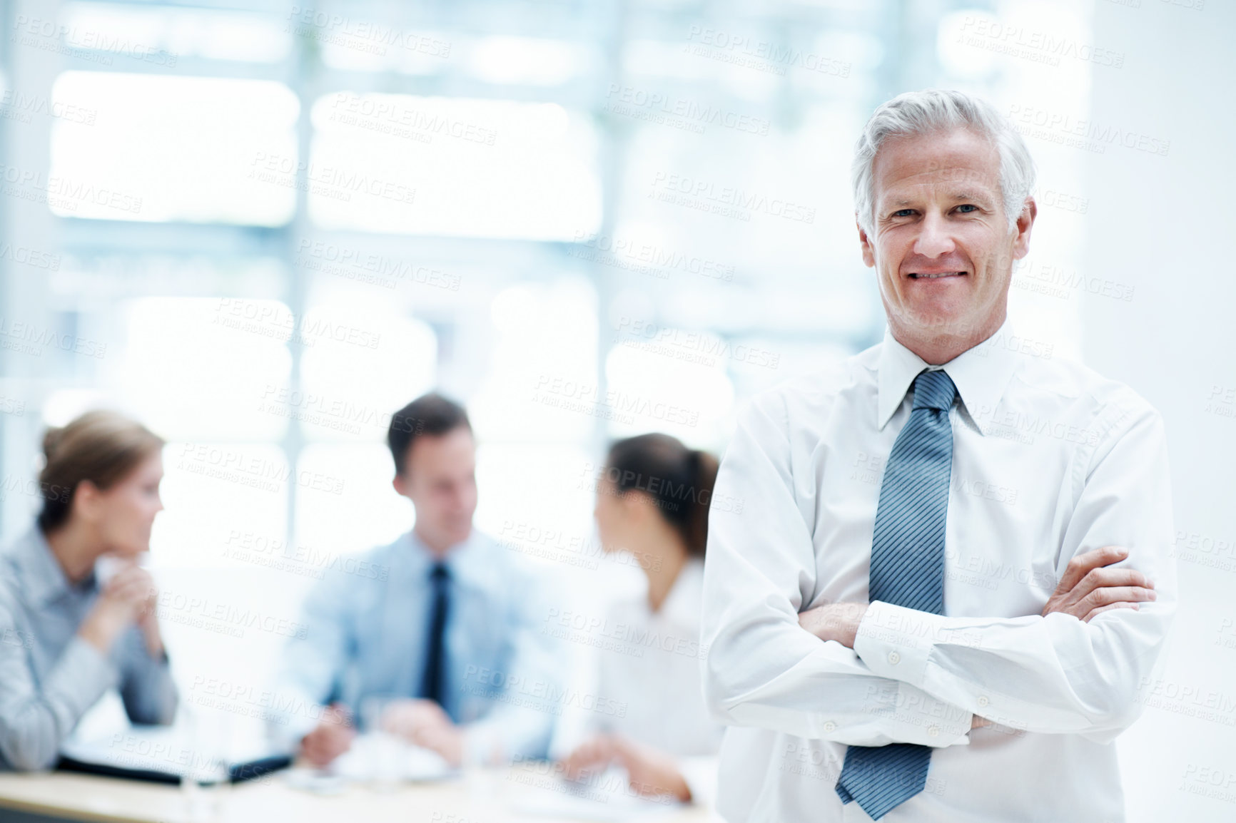 Buy stock photo Leader, meeting and businessman with arms crossed in office, wealth management or career development. Happy, portrait and mature person with colleagues, investment banking and business growth in USA