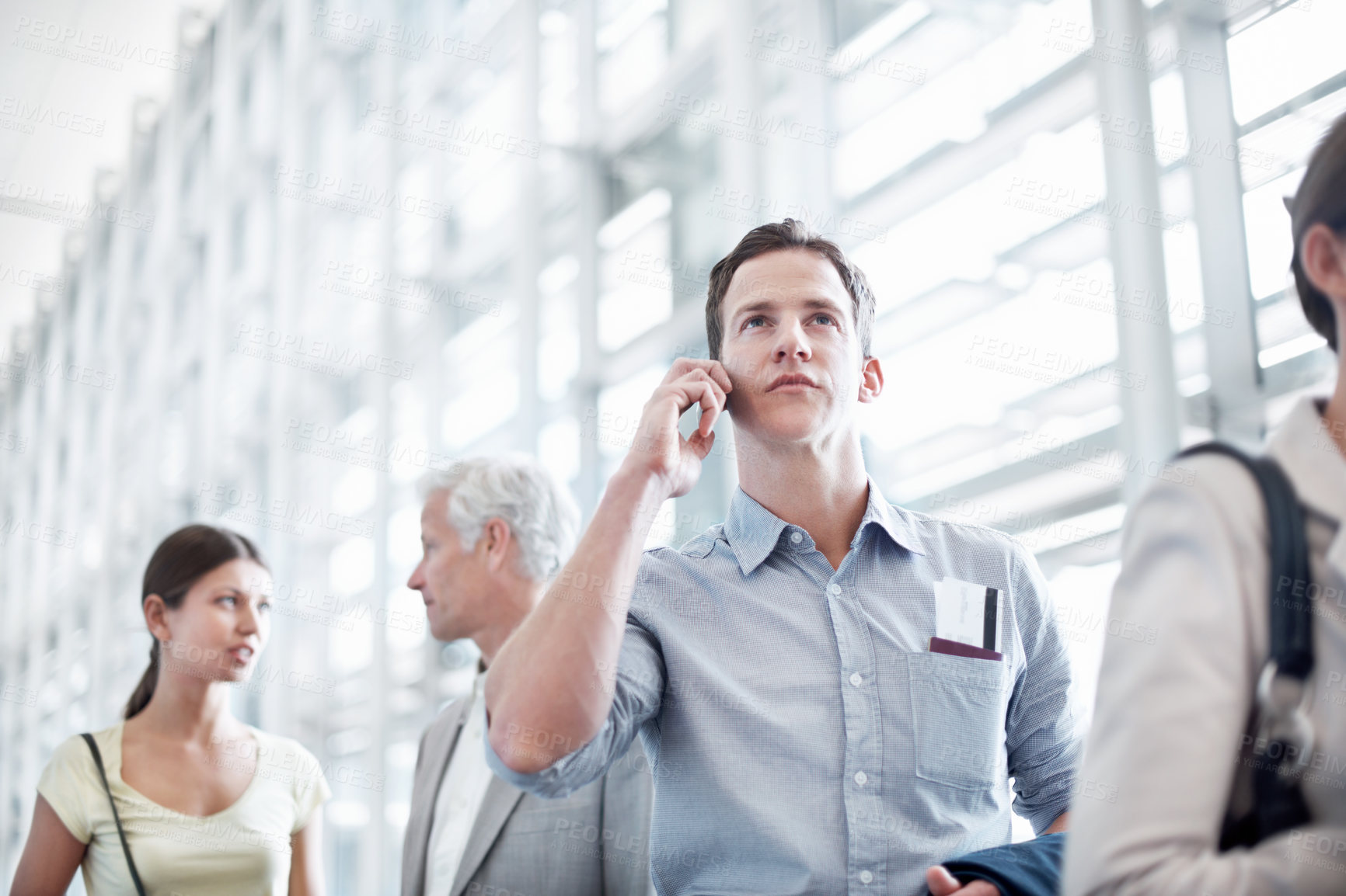 Buy stock photo Business travel, phone call and businessman in airport, chat and discussion with contact or thinking. Employee, communication and person with mobile, low angle and passport for international trip