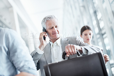 Buy stock photo Business travel, phone call and businessman with watch in airport, communication and flight updates. Check, time and mature person with mobile for chat, low angle and international job opportunity