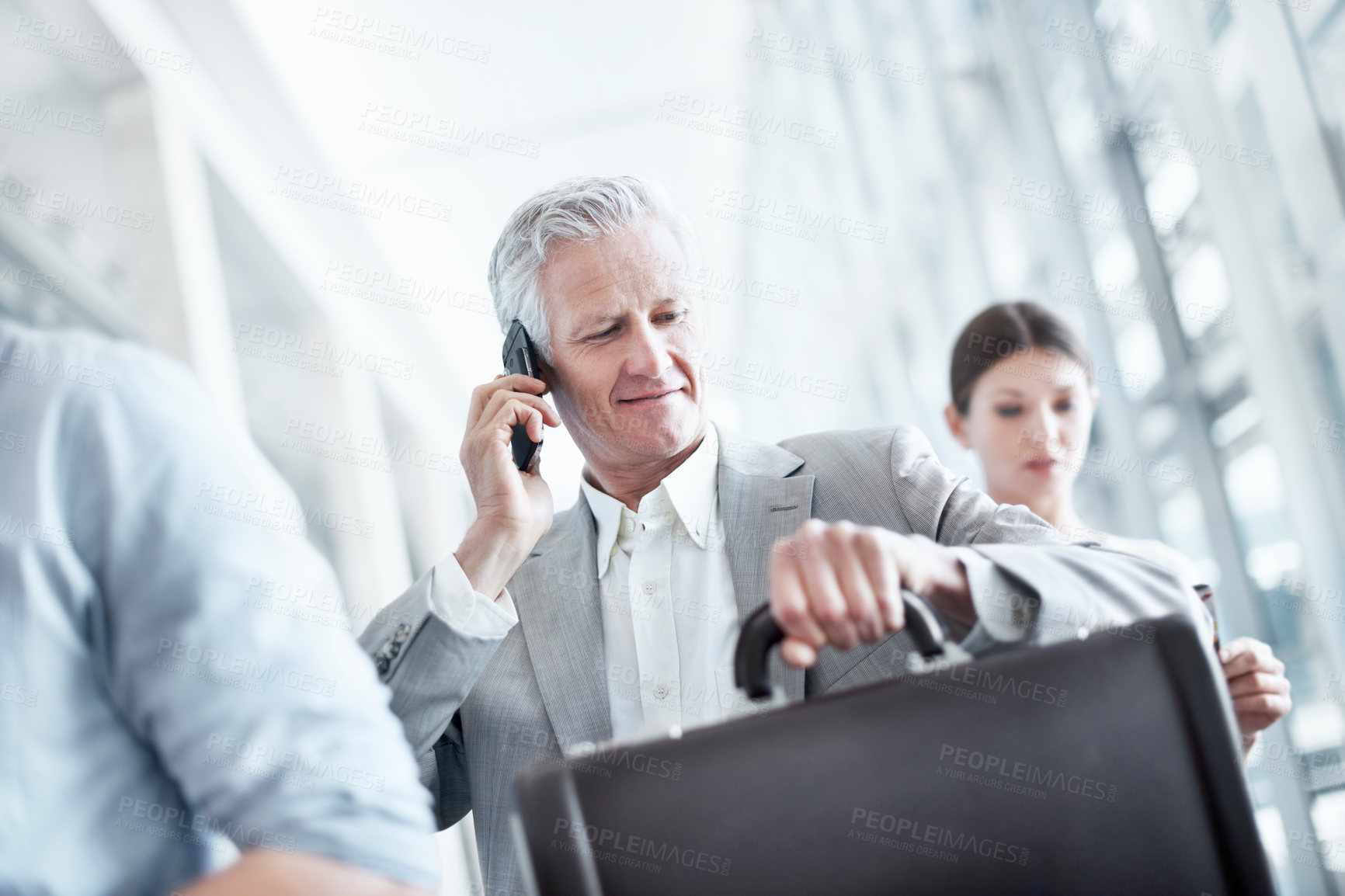 Buy stock photo Business travel, phone call and businessman with watch in airport, communication and flight updates. Check, time and mature person with mobile for chat, low angle and international job opportunity