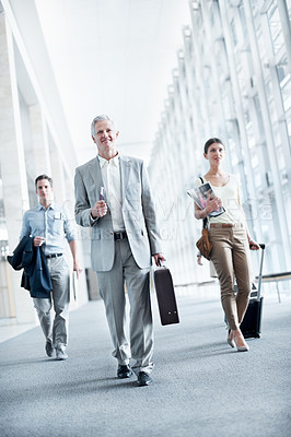 Buy stock photo Happy, walk or businesspeople at airport with travel, journey or commute to b2b seminar. Boarding, smile or employees in lobby with baggage, company trip or flight departure for corporate conference.