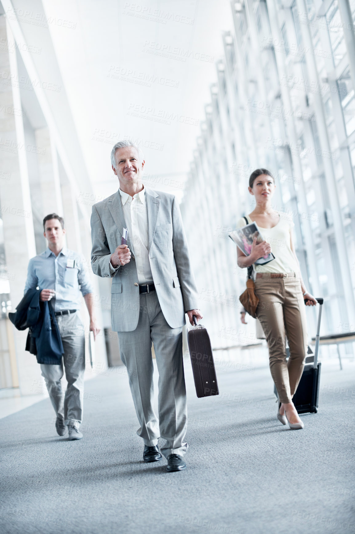 Buy stock photo Happy, walk or businesspeople at airport with travel, journey or commute to b2b seminar. Boarding, smile or employees in lobby with baggage, company trip or flight departure for corporate conference.
