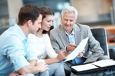 Buy stock photo Reading, documents and lawyer with couple in office for prenup agreement, meeting and advice. Marriage contract, legal advisor with man and woman in law firm for deal, estate planning and proposal