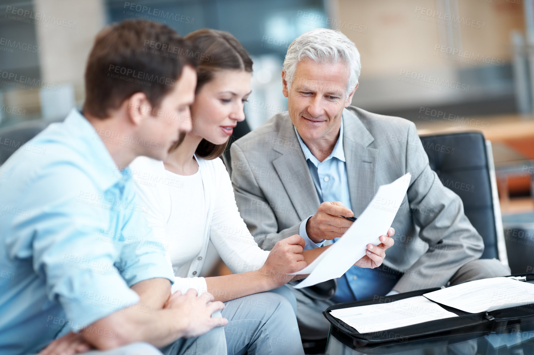 Buy stock photo Reading, documents and lawyer with couple in office for prenup agreement, meeting and advice. Marriage contract, legal advisor with man and woman in law firm for deal, estate planning and proposal