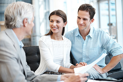 Buy stock photo Smile, couple and advisor in office with document, contract and finance report for funding. Happy, people and consultant in workplace with paperwork, review budget and loan application for investment