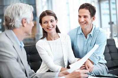 Buy stock photo Happy, documents and lawyer with couple in office for prenup agreement, meeting and advice. Marriage contract, legal advisor with man and woman in law firm for deal, estate planning and proposal