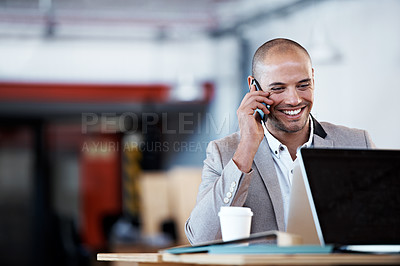 Buy stock photo Shot of a businessman talking on his cellphone while sitting at his desk in an office