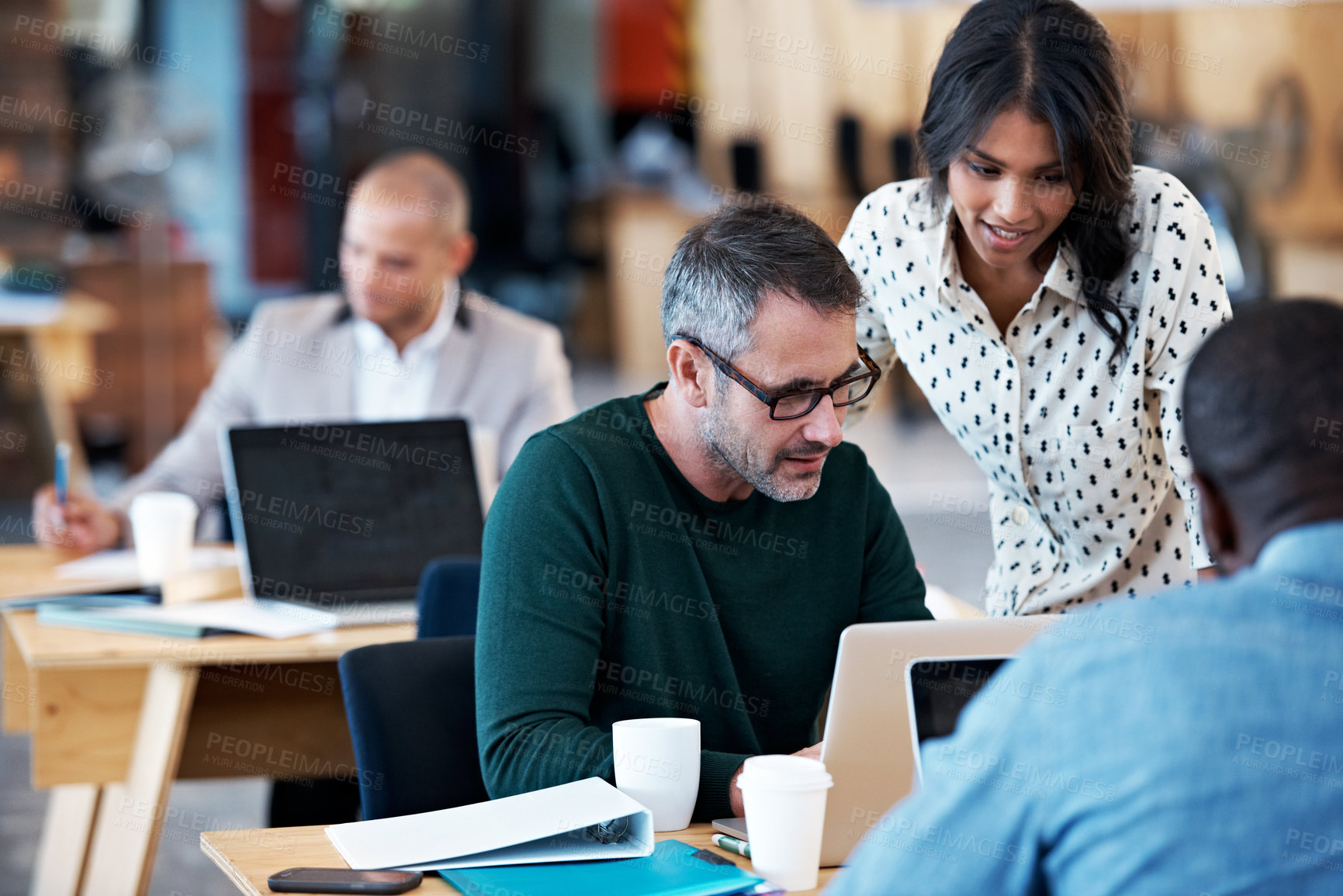 Buy stock photo Shot of a group of colleagues working in an office