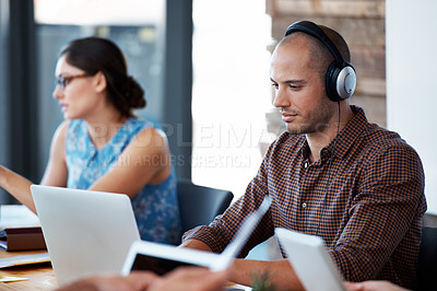 Buy stock photo Shot of colleagues working at their laptops in an office