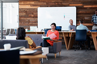 Buy stock photo Shot of colleagues sitting in a modern office