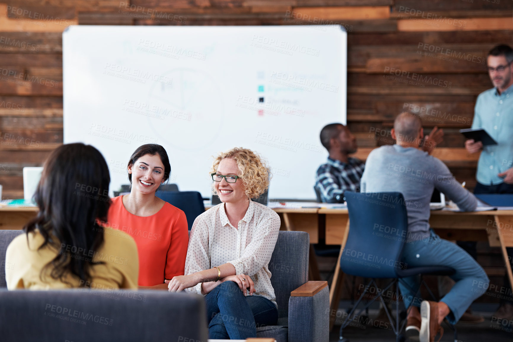 Buy stock photo Shot of colleagues sitting in a modern office