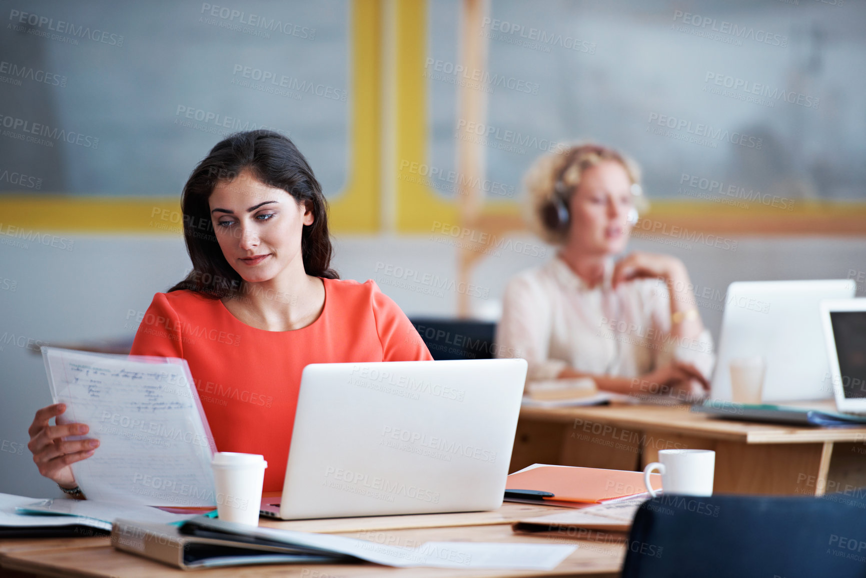 Buy stock photo Shot of a group of colleagues at work on laptops in an office