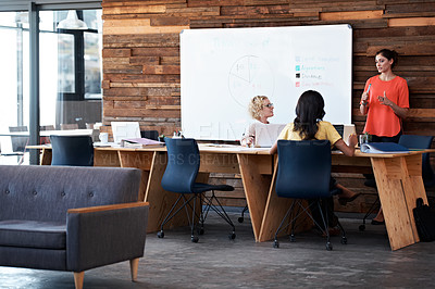 Buy stock photo Shot of a woman giving a presentation to colleagues in an office