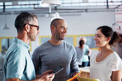 Buy stock photo Shot of a group of colleagues talking together while working in an office