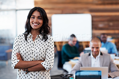 Buy stock photo Portrait of an office worker standing in an office with colleagues in the background