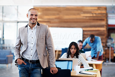 Buy stock photo Portrait of an office worker standing in an office with colleagues in the background