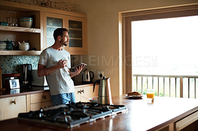 Buy stock photo Cropped shot of a handsome man eating breakfast in the kitchen