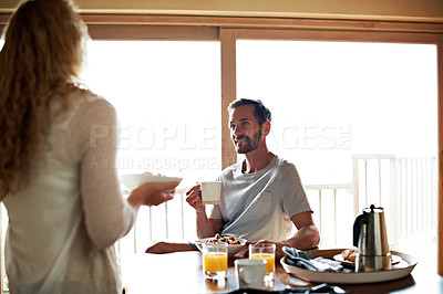 Buy stock photo Cropped shot of a couple having breakfast in the kitchen