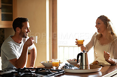Buy stock photo Cropped shot of a couple having breakfast in the kitchen