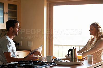Buy stock photo Cropped shot of a couple having breakfast in the kitchen
