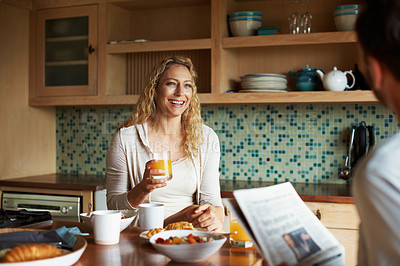 Buy stock photo Cropped shot of a couple having breakfast in the kitchen