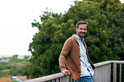 Buy stock photo Cropped shot of a handsome man standing outside on his deck