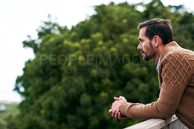 Buy stock photo Cropped shot of a handsome man standing outside on his deck
