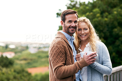 Buy stock photo Cropped shot of a couple standing outside on their deck