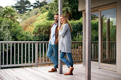 Buy stock photo Full length shot of a couple standing outside on their deck