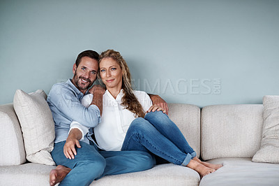 Buy stock photo Shot of a couple relaxing on their living room sofa