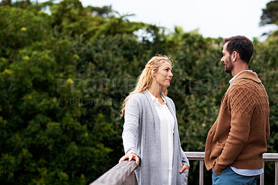 Buy stock photo Cropped shot of a couple talking outside on their deck