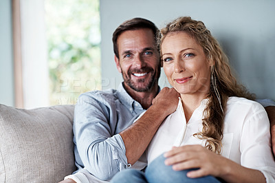 Buy stock photo Cropped shot of a couple relaxing on their living room sofa