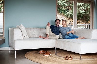 Buy stock photo Full length shot of a couple relaxing on their living room sofa
