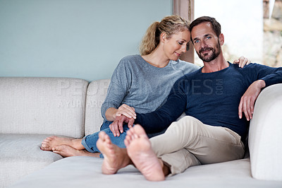 Buy stock photo Full length shot of an affectionate couple relaxing on their living room sofa