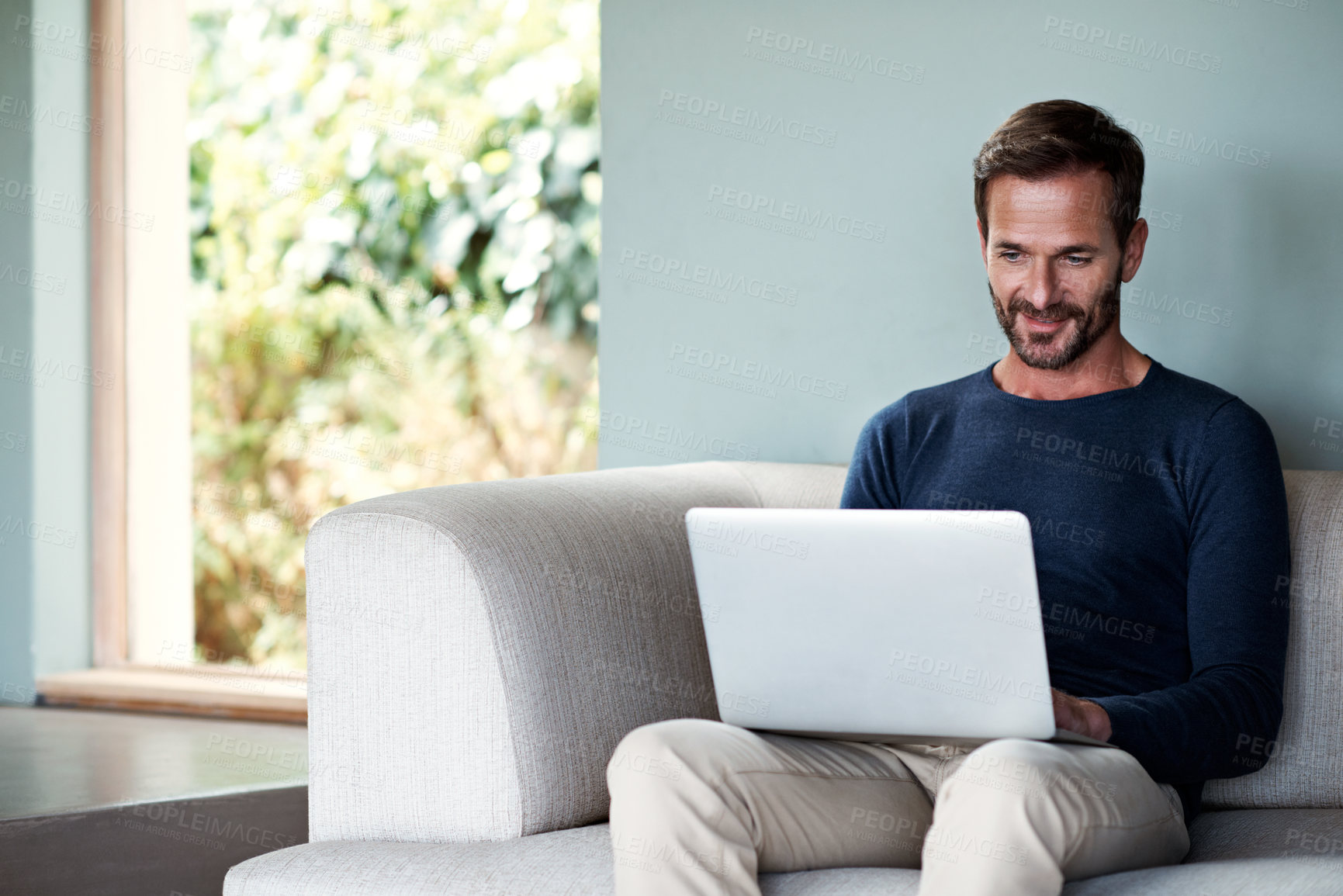 Buy stock photo Freelancer, research and man with laptop in living room, copywriting or smile for article on website. Copywriter, remote work and mature person with tech in lounge, info or editing blog post in house