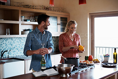 Buy stock photo Cropped shot of a couple cooking in the kitchen