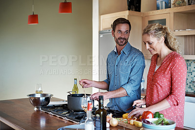 Buy stock photo Cropped shot of a couple cooking in the kitchen