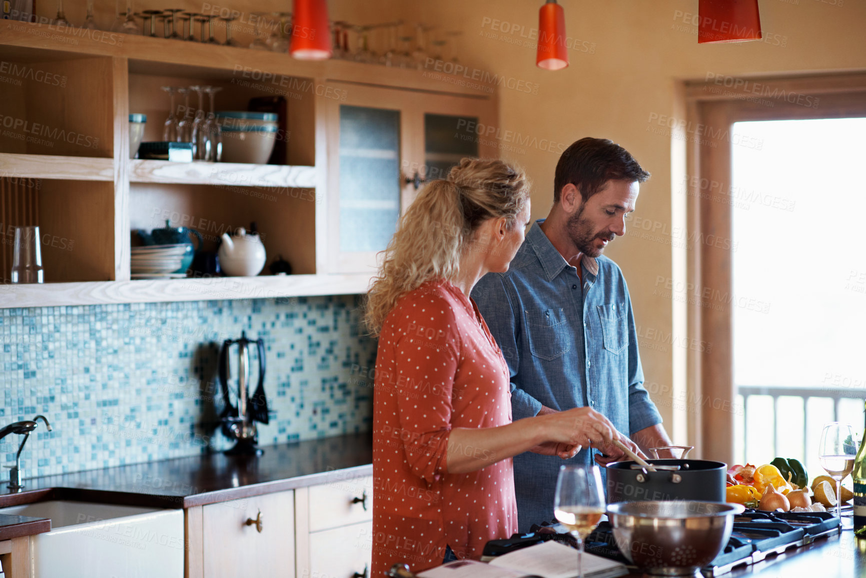 Buy stock photo Cooking, talking and couple in kitchen by stove for bonding with help, meal prep or healthy dinner. Marriage, home or mature man with woman with ingredients, vegetables and recipe for supper or lunch