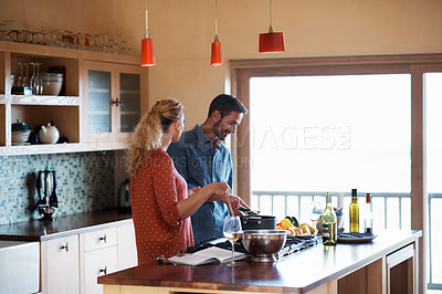 Buy stock photo Cropped shot of a couple cooking in the kitchen