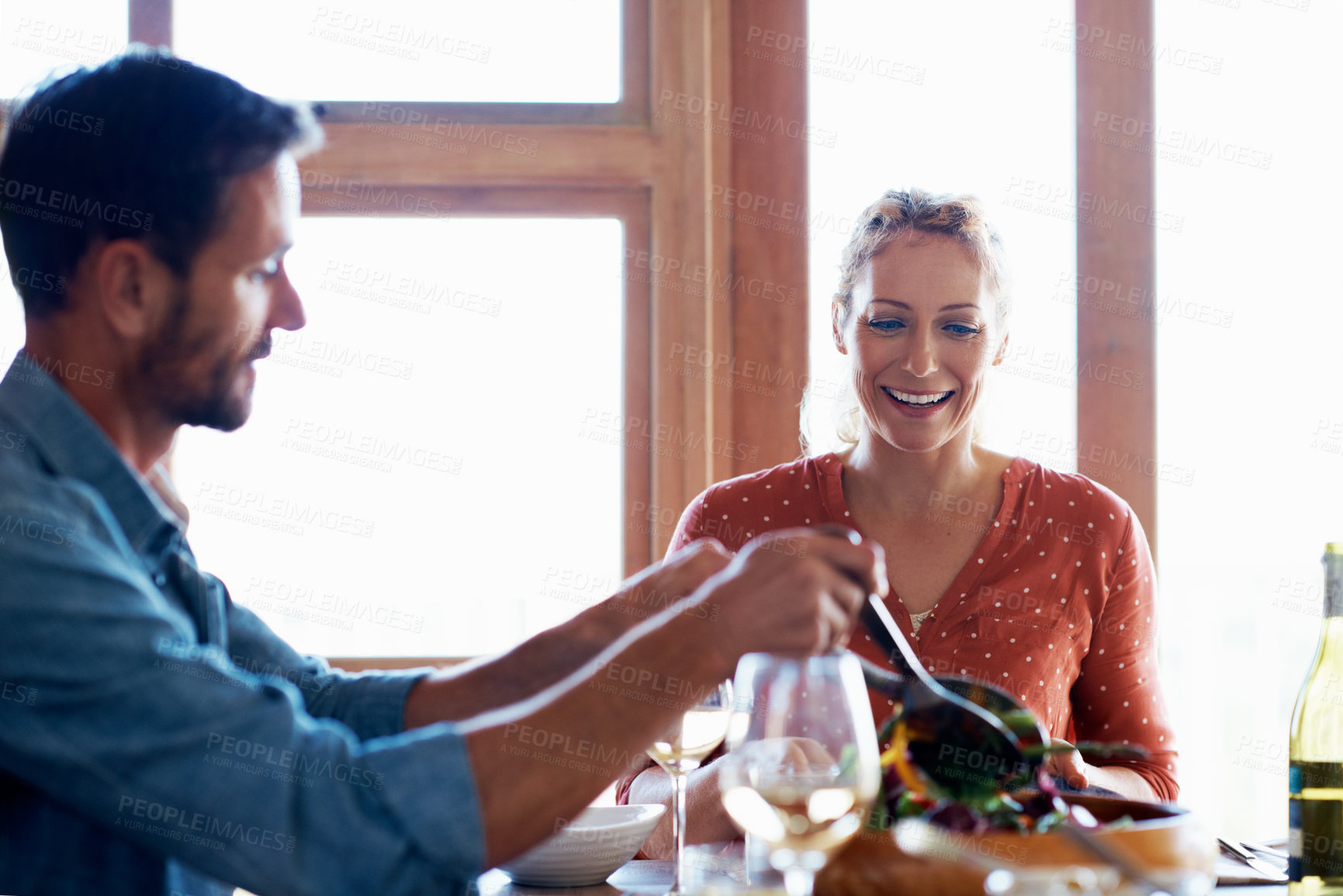 Buy stock photo Cropped shot of a couple having a romantic dinner at home