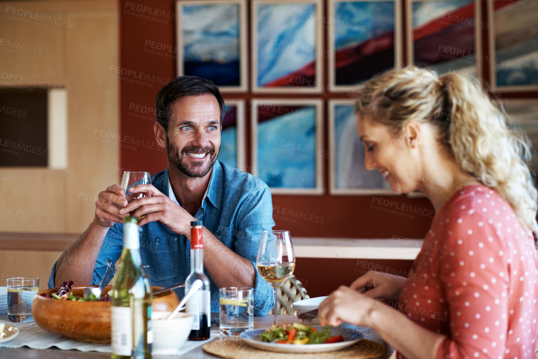 Buy stock photo Cropped shot of a couple having a romantic dinner at home