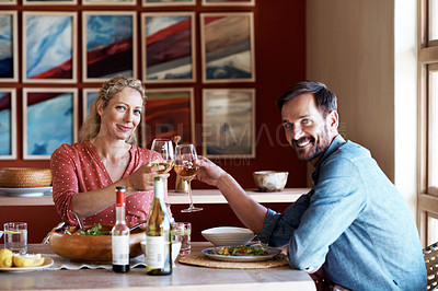 Buy stock photo Cropped portrait of a couple having a romantic dinner at home