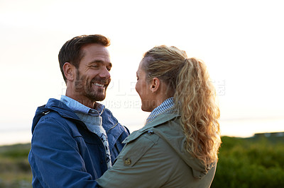 Buy stock photo Cropped shot of an affectionate couple standing face-to-face outdoors