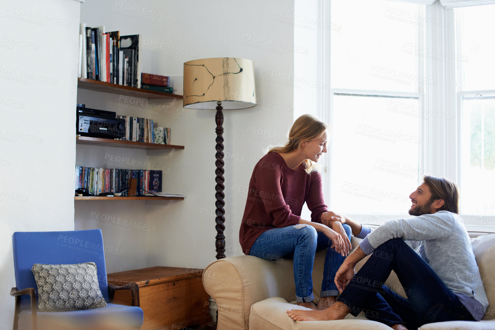 Buy stock photo Couple, break and laughing on couch in house, rest and smile with partner in living room or bonding. Happy people, love and connection with spouse in lounge, romance and marriage commitment in home