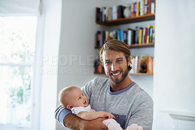 Buy stock photo Portrait of a smiling father holding his baby girl at home