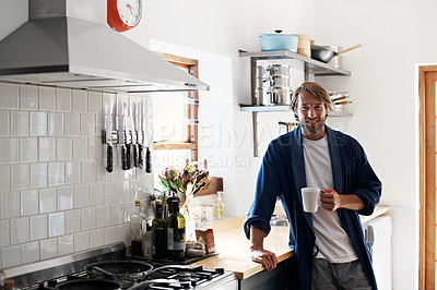 Buy stock photo Portrait of a young man drinking a coffee in the kitchen in the morning