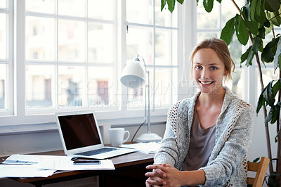 Buy stock photo Portrait of a young woman sitting at her laptop at home