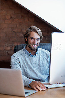 Buy stock photo Portrait of a young man working on a computer in his study at home