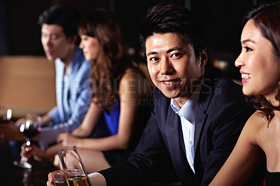 Buy stock photo Shot of a young couple enjoying a night out together in a bar