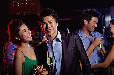 Buy stock photo Portrait of a young couple enjoying a night out together in a club